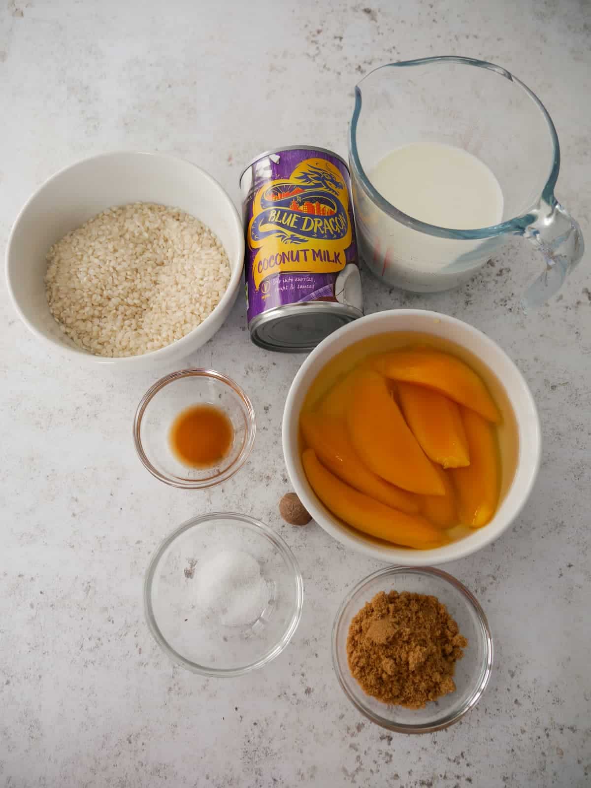 Individual recipe ingredients for coconut rice pudding with mango.