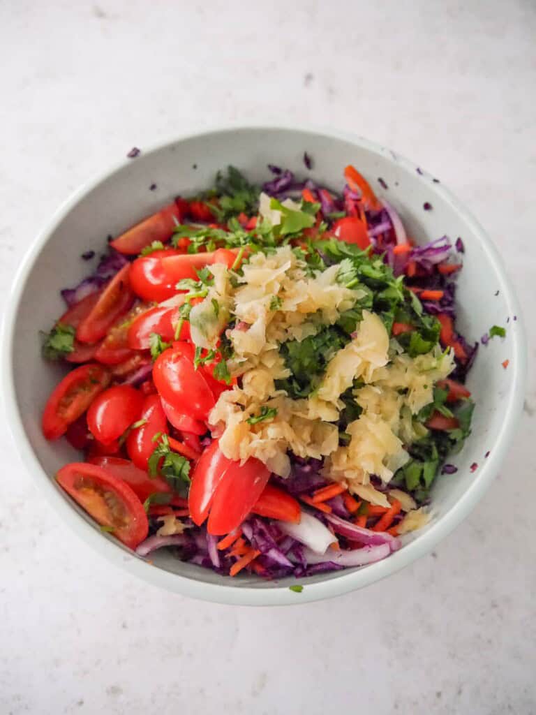 A bowl of ingredients for making peanut and ginger slaw.