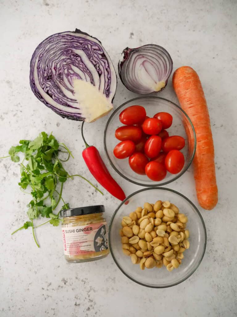 Individual recipe ingredients for making peanut and ginger slaw.