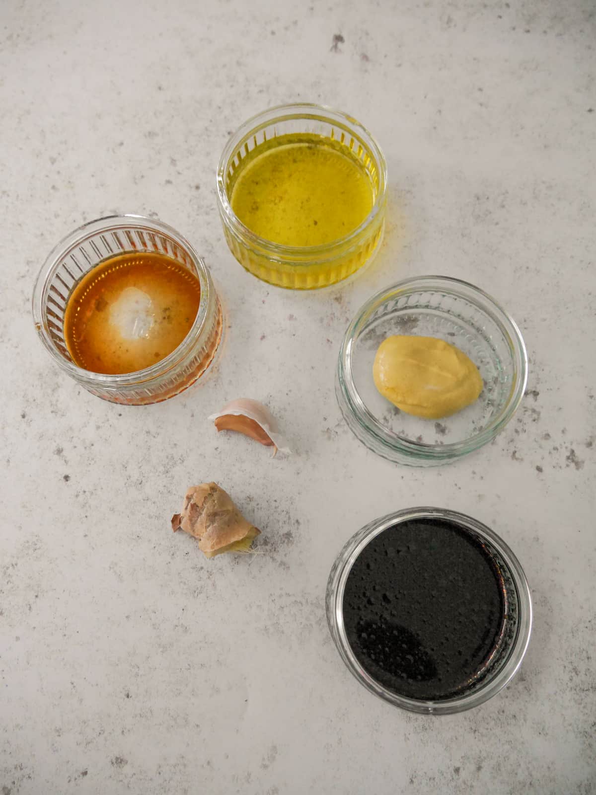 Individual recipe ingredients for making soy and ginger dressing.