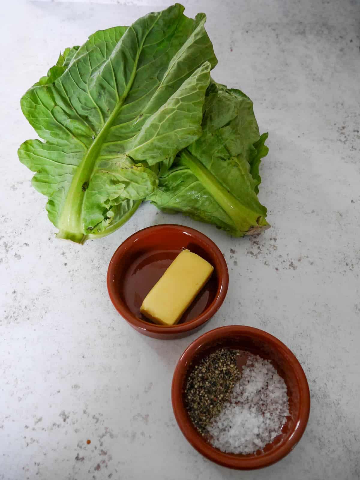 Individual recipe ingredients for making buttered spring greens.