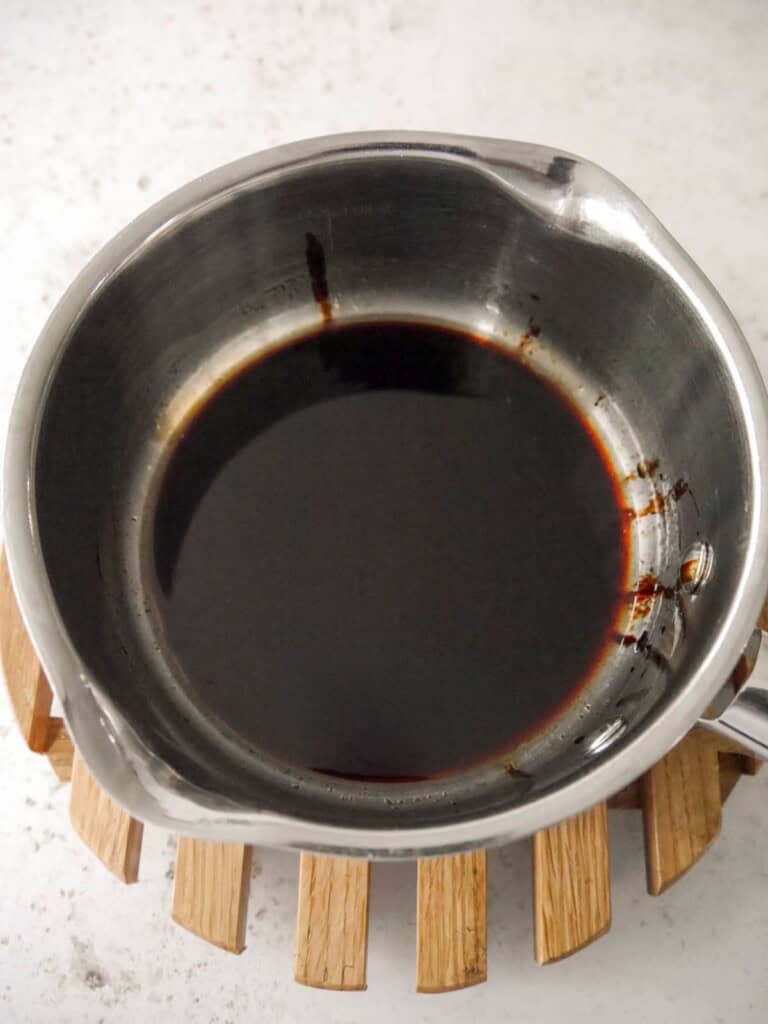 A saucepan with a hot soy and sesame sauce.