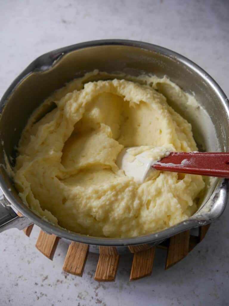 A saucepan of creamy mashed potatoes.