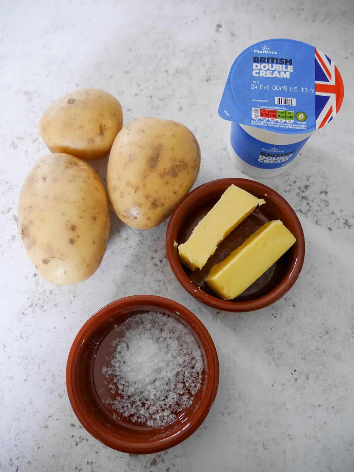 Individual recipe ingredients for making creamy mashed potatoes.