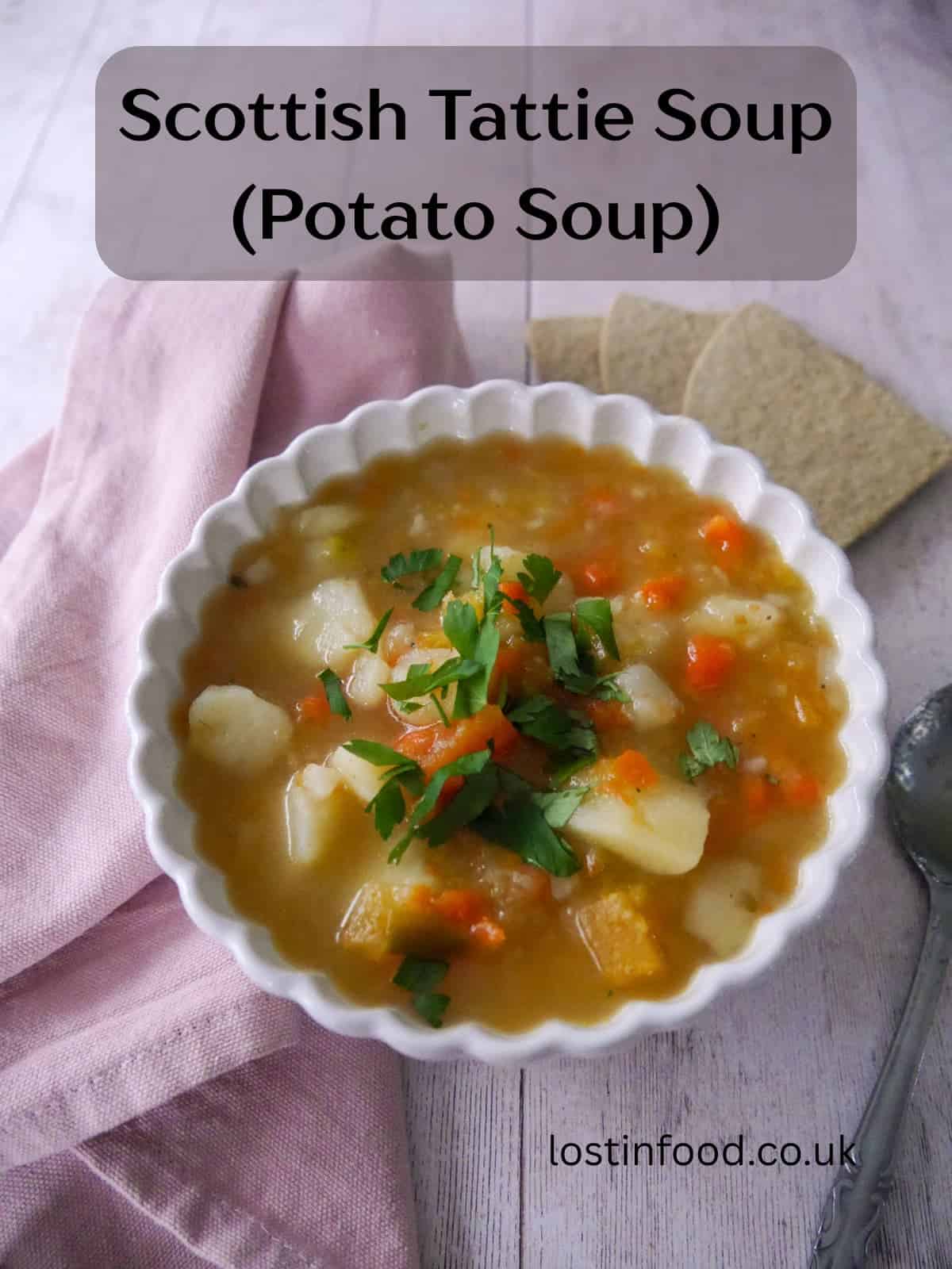 Pinnable image with recipe title and a bowl of potato and vegetable soup with some oatcakes served alongside.