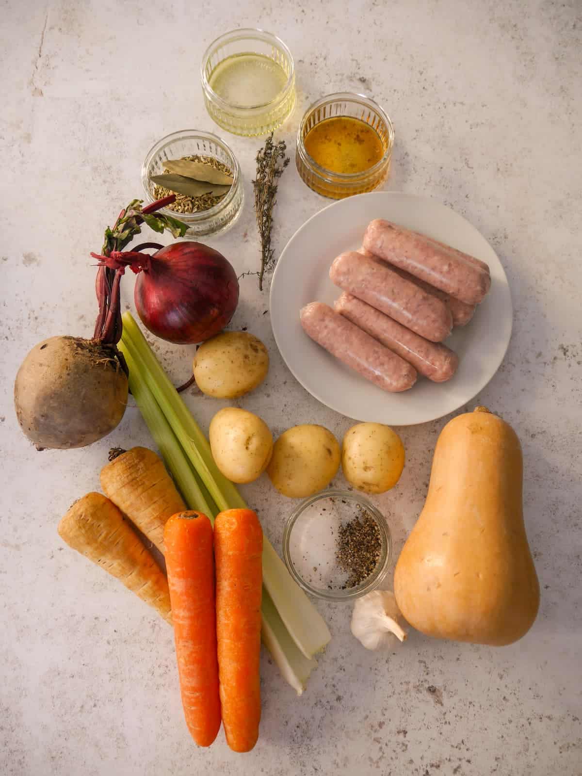 Individual recipe ingredients for making sticky sausage traybake.