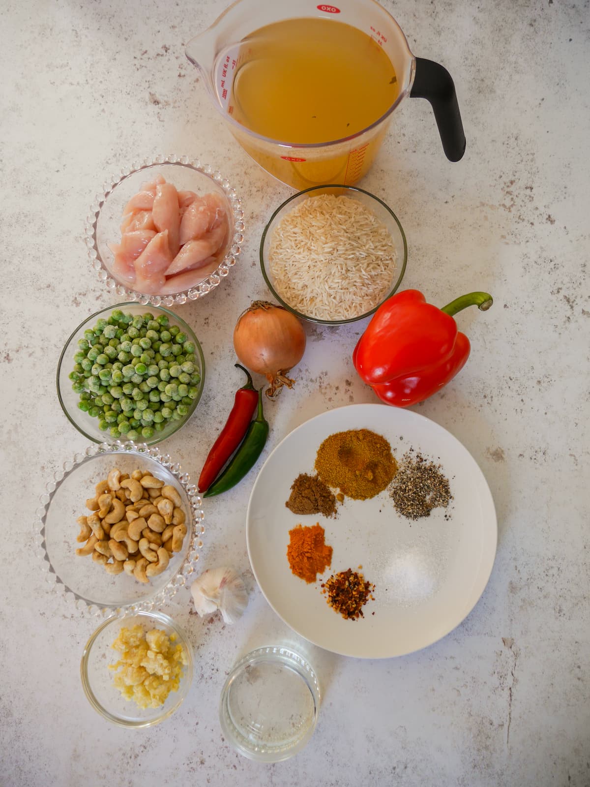 Individual recipe ingredients for making one pot curried chicken and rice.