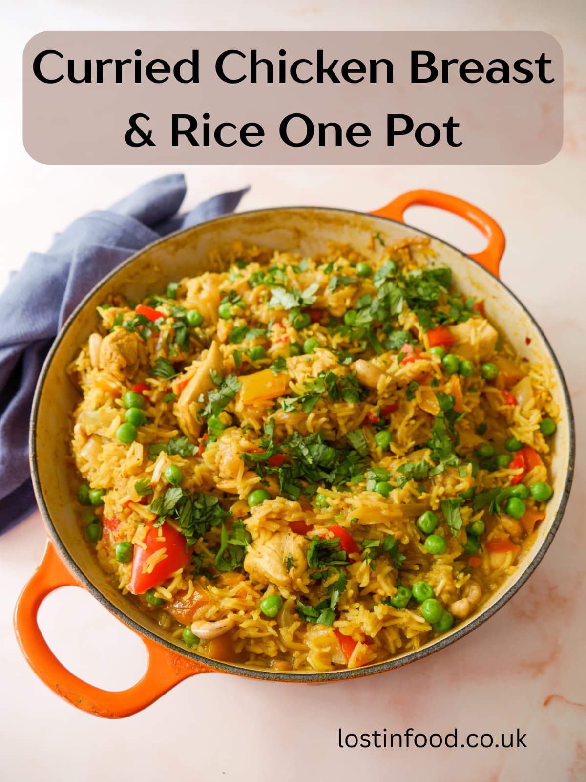 Pinnable image with recipe title and a large skillet of curried chicken and rice with added vegetables and cashew nuts, and garnished with coriander leaf.