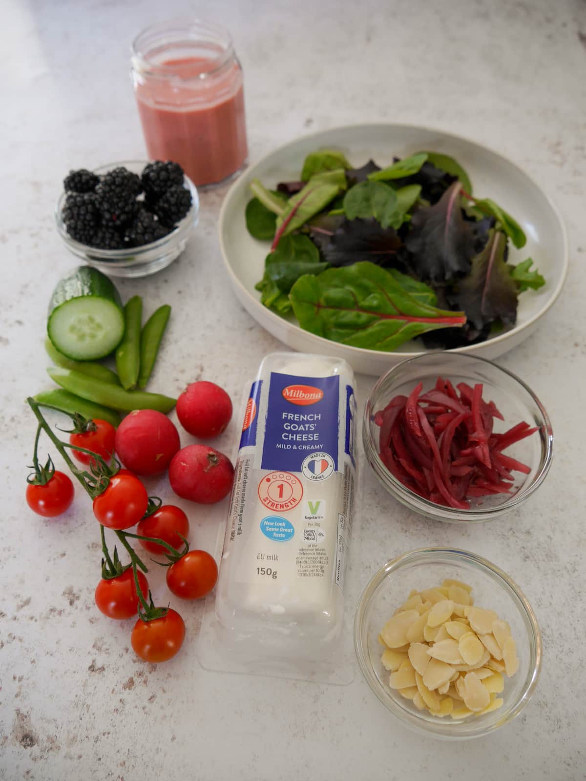 Individual recipe ingredients for making goat's cheese and blackberry salad.