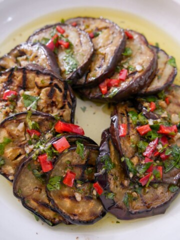 A bowl filled with Italian marinated aubergine slices.