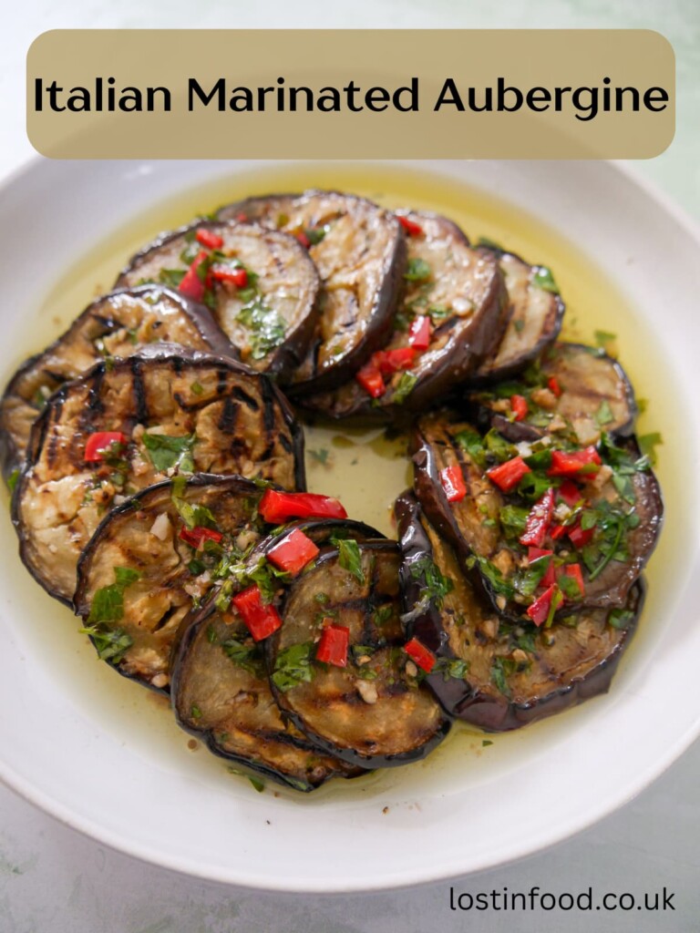 Pinnable image with recipe title and a bowl filled with Italian marinated aubergine slices.