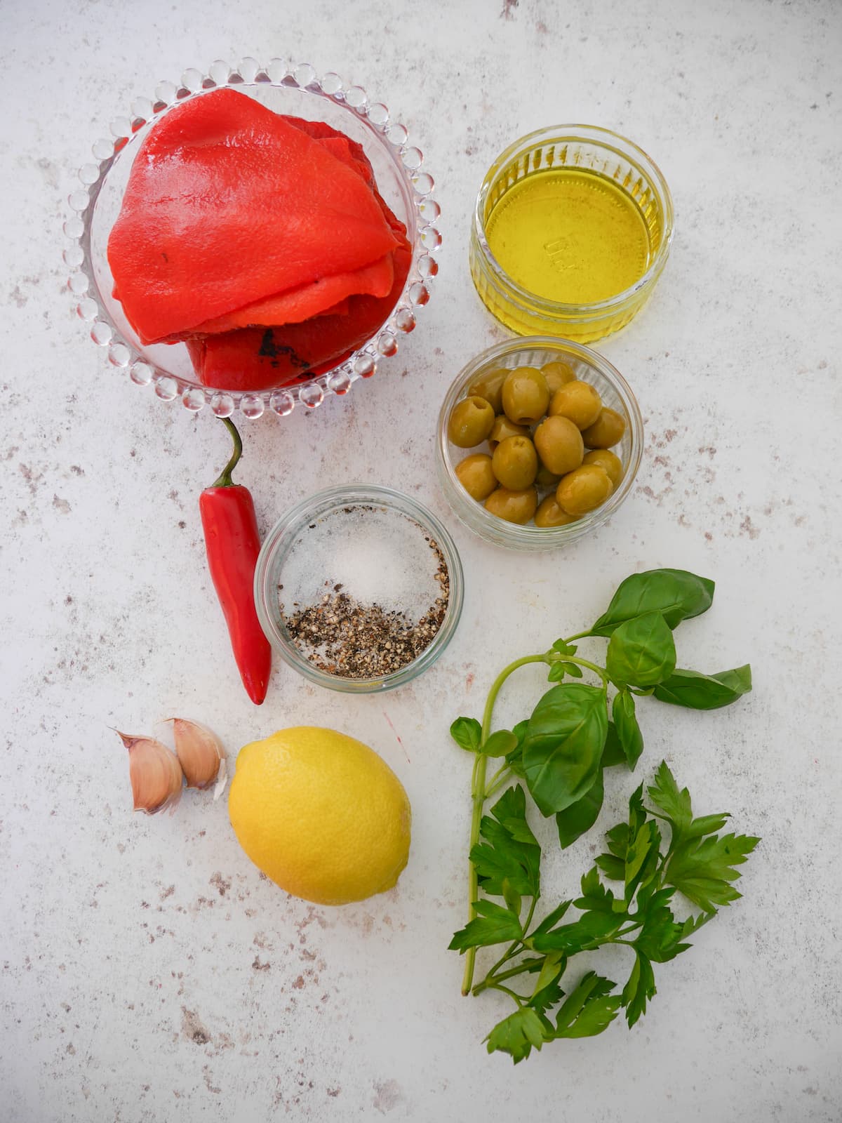 Individual recipe ingredients for making roasted red pepper dip.