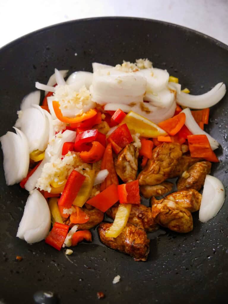 Stir fried chicken with added sliced white onion, red and yellow peppers, and crushed garlic.