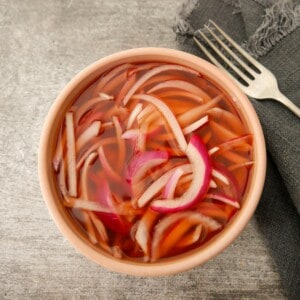A bowl of quick pickled red onion.