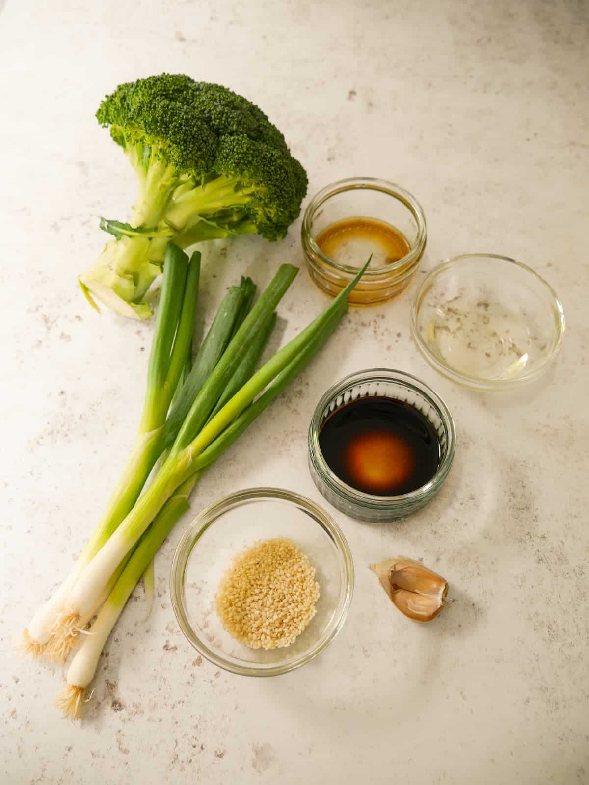 Individual recipe ingredients for making stir-fried broccoli.