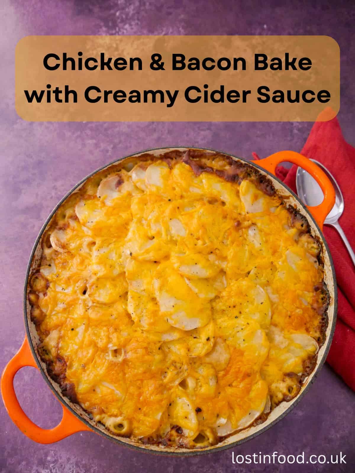 Pinnable image with recipe title and a cast iron skillet filled with chicken and bacon bake in a cider sauce.