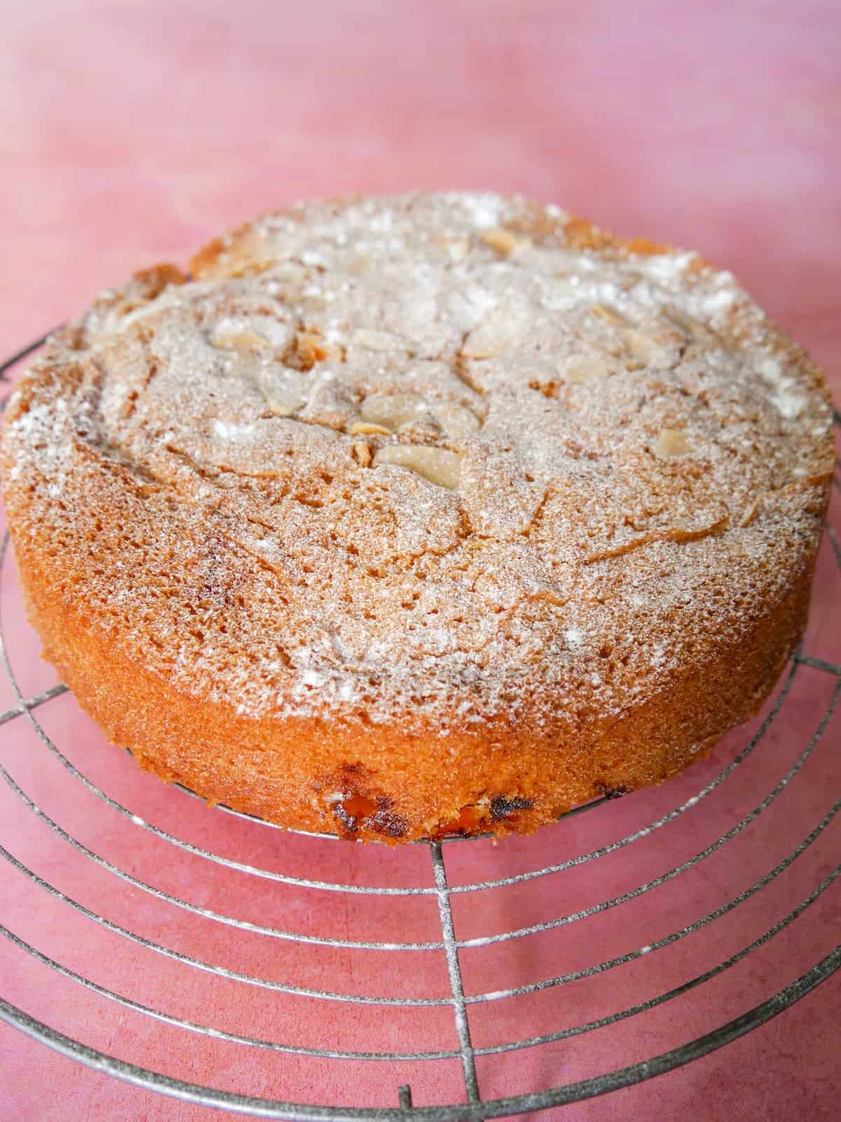 Fresh apricot cake set on a wire cooling rack.