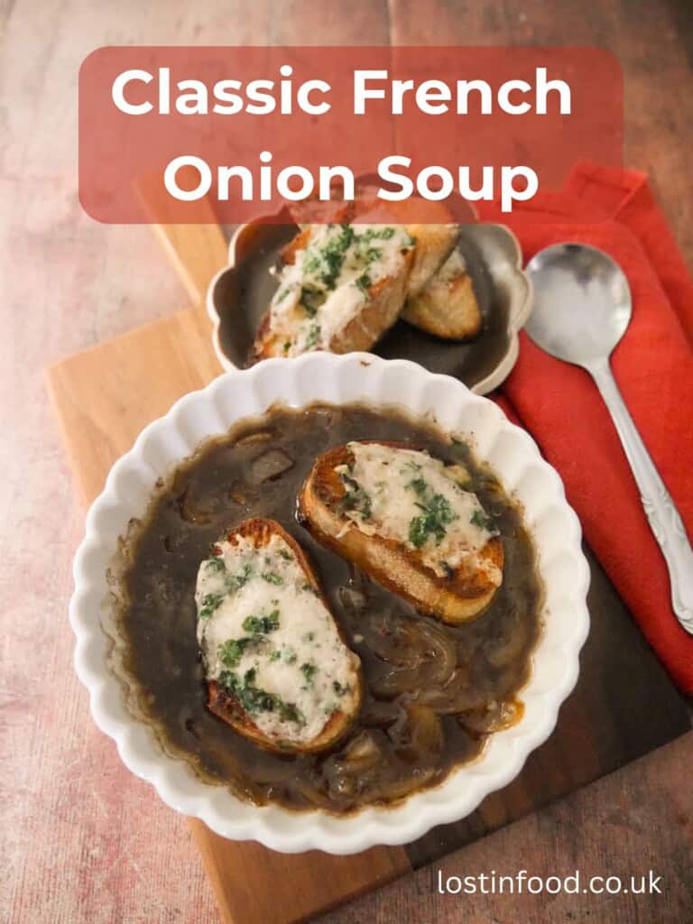 Pinnable image with recipe title and a bowl of French onion soup, topped with 2 slices of toasted baguette topped with melted gruyere cheese.