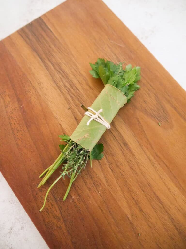 Sprigs of fresh thyme and parsley wrapped in a bay leaf and tied with kitchen string to make a bouquet garni.