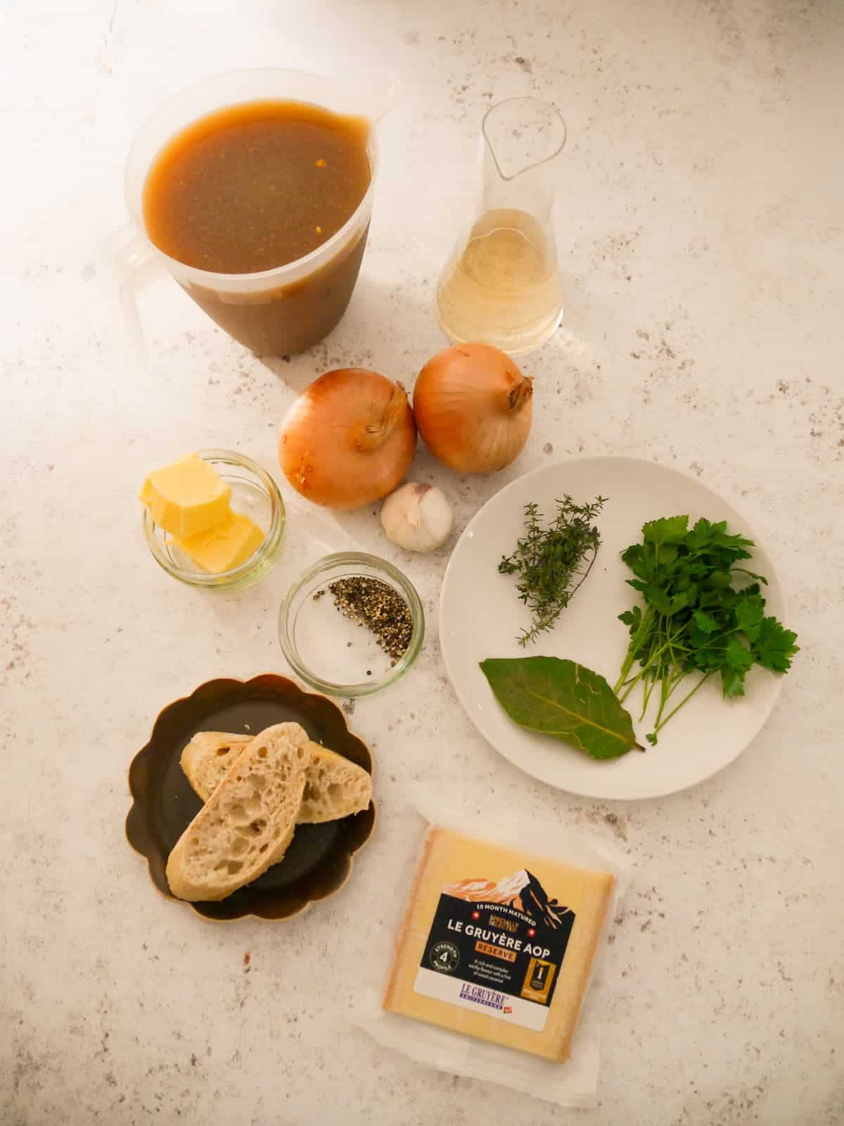 Individual recipe ingredients for making French onion soup.