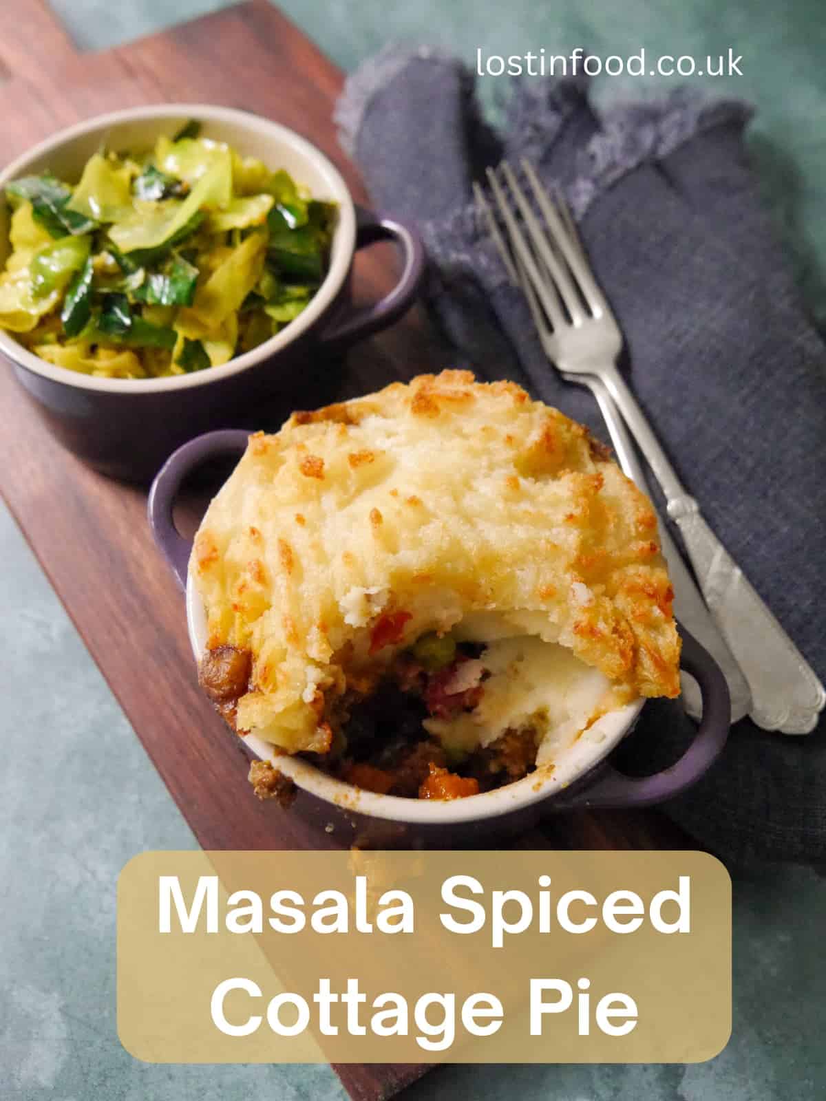 Pinnable image with recipe title and a small dish of masala spiced cottage pie, served with a bowl of mustard spiced cabbage set alongside.